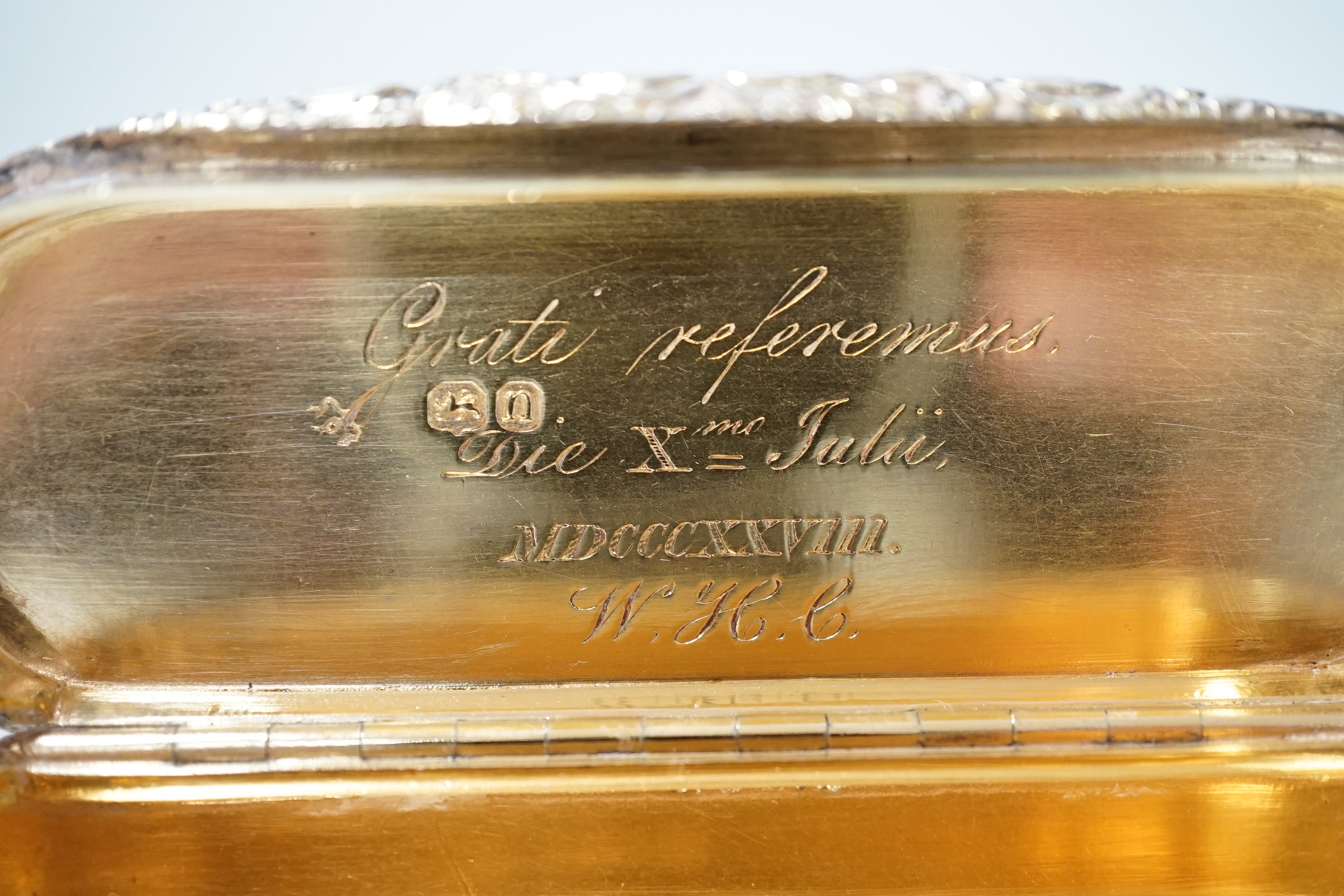 A George IV engine turned silver gilt oval snuff box, with interior Latin inscription, John Linnit, London, 1828, 9cm.